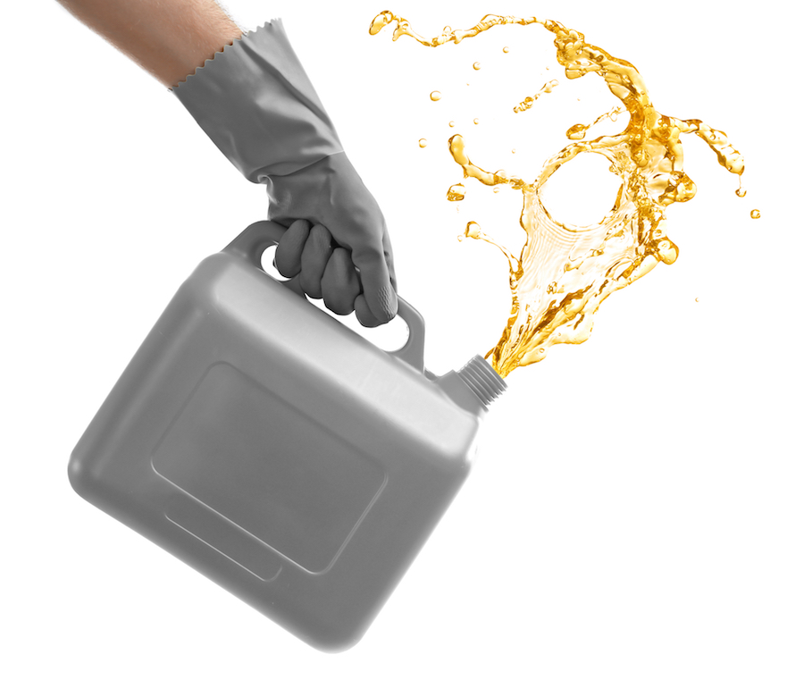 Man pouring oil out of plastic canister on white background